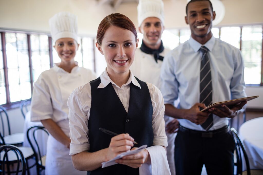 Hotel staff team standing together in a hotel lobby