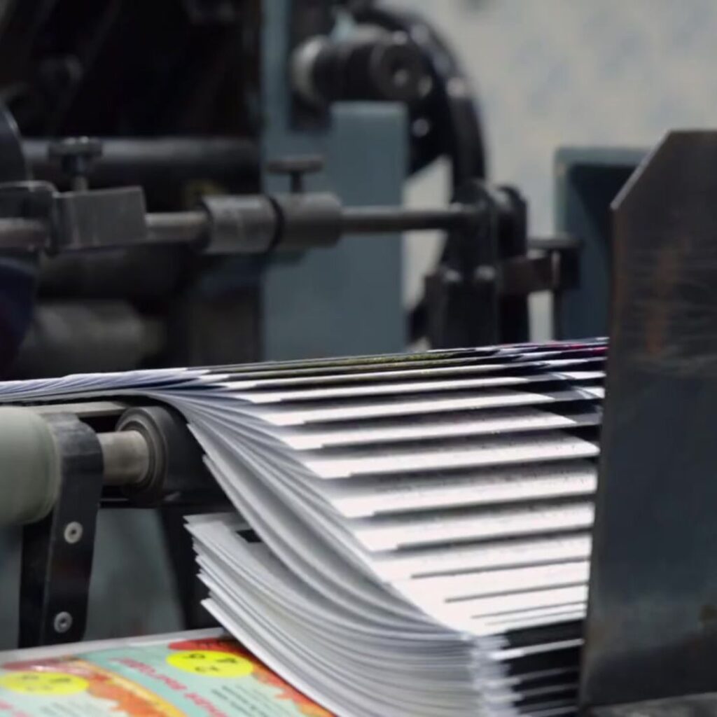 Publisher: A machine with a stack of papers